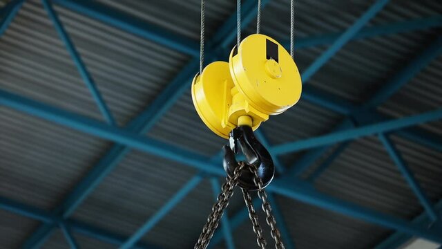 Crane and hook. Hook a crane  yellow color, Close up crane hook for overhead crane in factory or warehouse