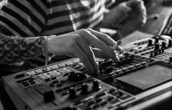 Close up detail of hamds adjusting stereo/sound mixer