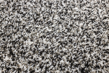 Abstract texture of gray-white-black soft fleecy rug, background.