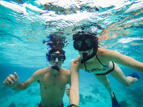 Couple Snorkling in Clear Blue Waters Above a Shipwreck