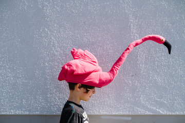boy wearing a flamingo hat
