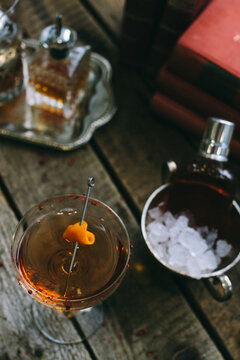 classic manhattan cocktail with orange peel on a wooden board from above