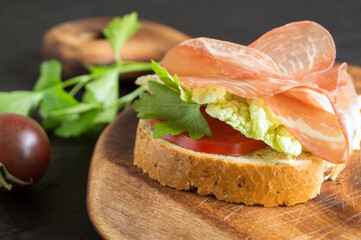 Open sandwich with ham slices on whole grain bread.