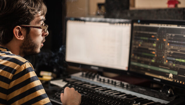 DJ/audio producer working in his music studio