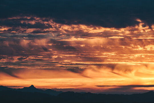 dramatic cloud formation above austrian mountains at sunset