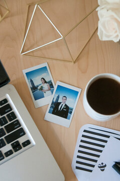Polaroid pictures of bride and groom on a busy desk