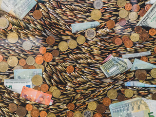 a huge pile of coins and banknotes