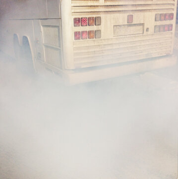Exhaust pipe smoke of an old bus