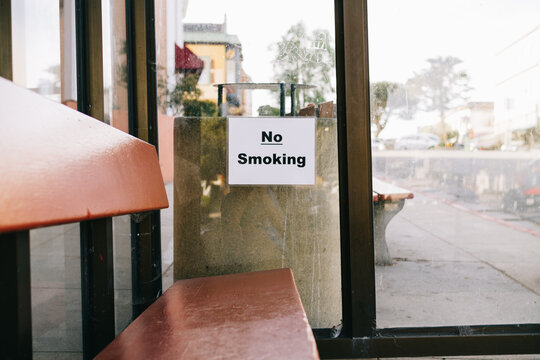 no smoking sign posted inside bus stop