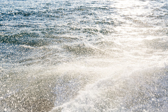 Fine mist of sea spray as water hits rocks