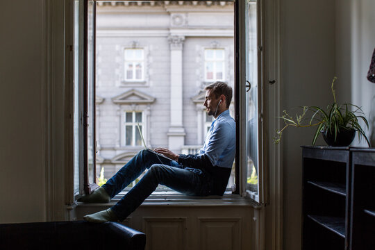 Man sitting at the window and working on a computer