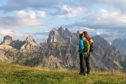 Couple looking at the view of Dolomites Mountains