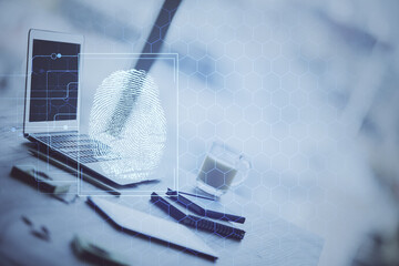 Computer on desktop in office with finger print drawing. Double exposure. Concept of business data security.