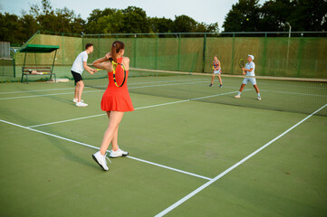 Obraz premium Mixed doubles tennis players, outdoor court