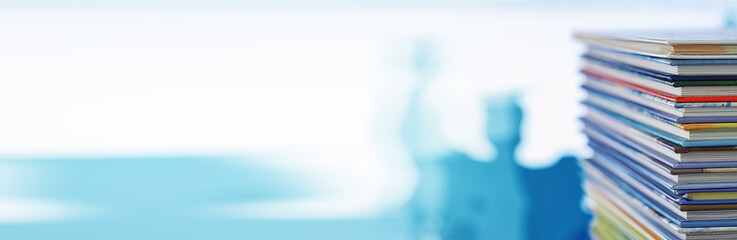 A stack of books. Textbooks on the table. Tutorials are on the desk.