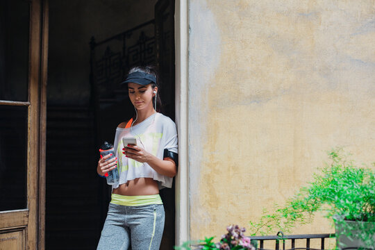 Woman in Fitness Clothes Using a Mobile Phone