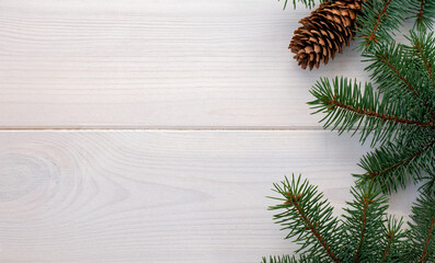 Christmas fir tree with pinecones on a white wooden board and copy space for your text. Banner.Flat lay