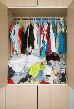 Messy kid's wardrobe BEFORE major decluttering and purging as new year resolution