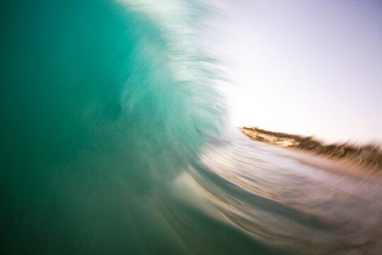 Slow shutter speed/water shot of a breaking wave at sunset.