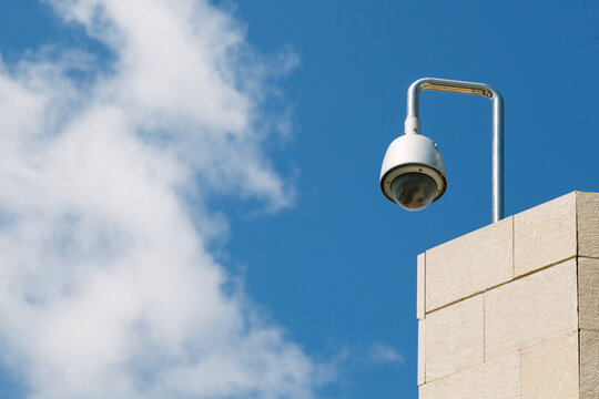 Security Cam on a Top Roof Against a Radiant Blue Sky