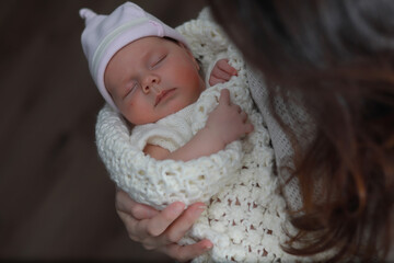 Fototapeta na wymiar Baby newborn sleeping wrapped up in a blanket
