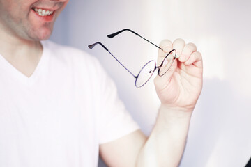 The concept of poor vision. Hold a contact lens and glasses in hand. A poster for advertising...