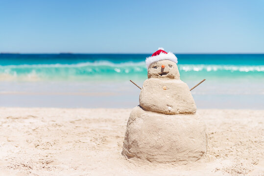 Sand snowman at the beach at Christmas in Australia