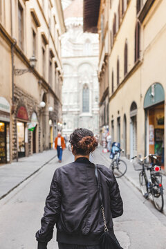 Young Woman Walking Through the Street of Florence in Italy