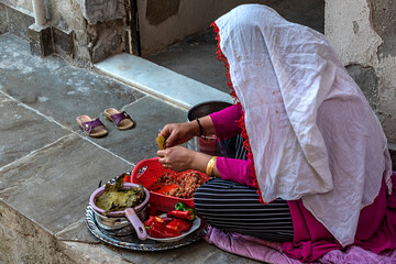 woman cooking wrap dinner on the street