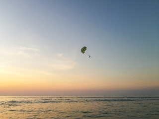 Parachute flight over the Andaman Sea in Thailand on a warm evening.