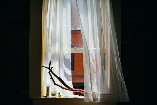 Window with Curtains Blowing in the Wind