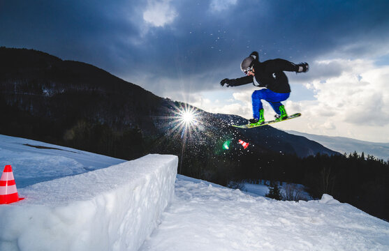 Snowboarder doing a backflip jump