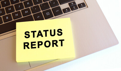 Notepad with the text is on the laptop keyboard. Minimal work space. Business concept.