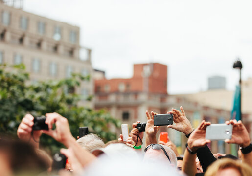 Crowd Shooting Photos on Street