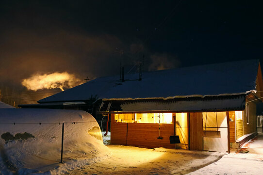 Illuminated village cottage at night
