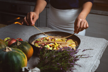 Preparation, Thanksgiving Day celebration. The chef decorates the surface of the pie with strips of dough over the apple filling. Making a traditional apple pie.