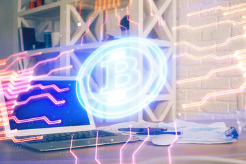 Double exposure of blockchain theme hologram and table with computer background. Concept of bitcoin crypto currency.
