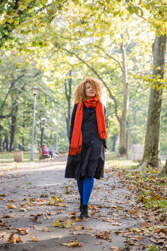 Woman walking in a park on an autumn day