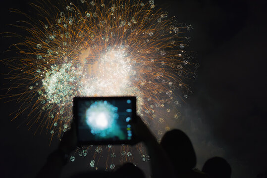 Watching Fireworks with a tablet at Holiday Celebration,shanghai,china