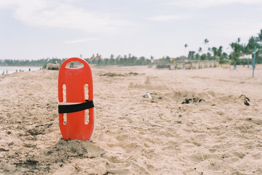 Orange lifeguard buoy on at white sand Caribbean beach