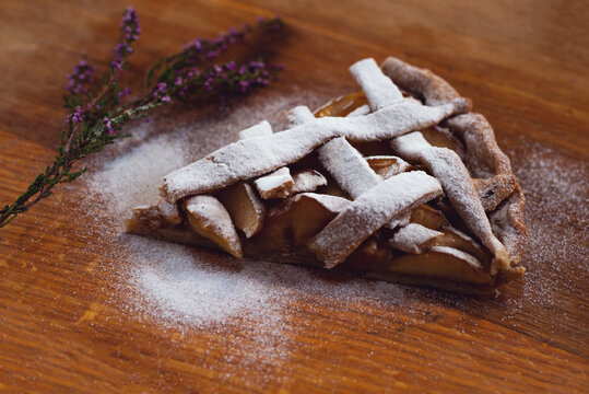 Thanksgiving Day Celebration. Side View Of A Slice Of Traditional Apple Pie Next To A Sprig Of Heather.