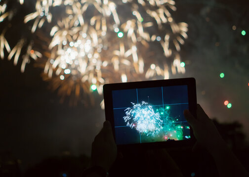Watching Fireworks with a tablet at Holiday Celebration,shanghai,china