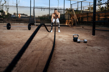 Man doing exercise with ropes, workout, crossfit