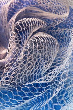 Closeup of plastic mesh material, twists, curves, highlights, shadows