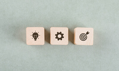 Target concept with wooden blocks on sage color background flat lay. free space for your text....