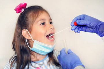 Doctor Doing Coronavirus covid-19 Test For girl Patient wearing a medical mask. Taking a saliva sample from a man. DNA test. control testing after treatment for covid 19