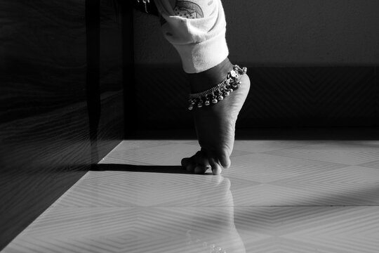 Indian girl child silver anklet isolated in bare feet