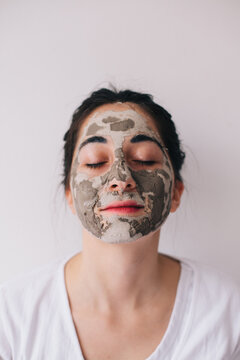 Portrait of a beautiful brunette woman with cosmetic facial mask
