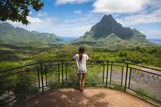 Woman looking out over a beautiful island landscape.