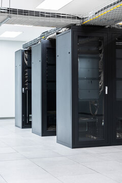 Servers in aisle of storage cabinets in data center